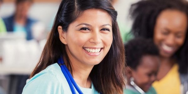 Smiling healthcare professional in scrubs with stethoscope